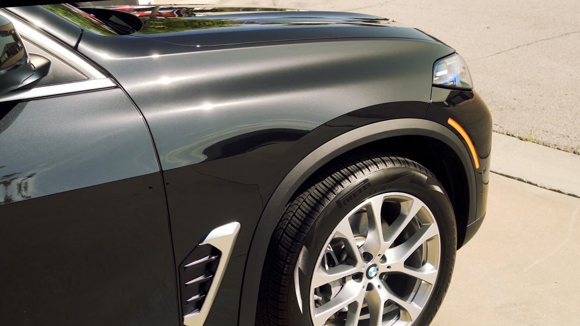 Glossy BMW receiving professional ceramic coating for long-term paint protection
