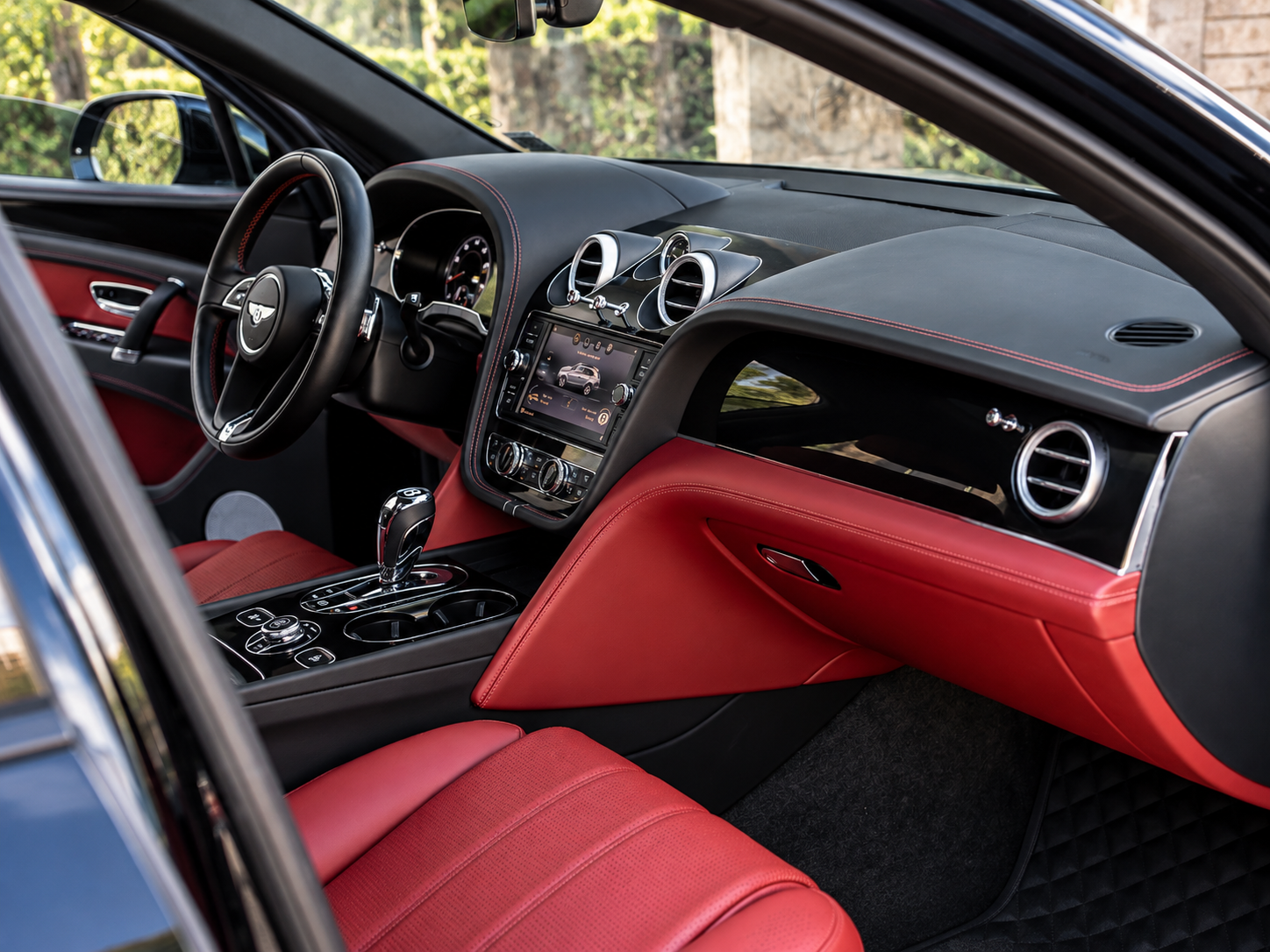 Luxury red leather Bentley-style interior after professional detailing