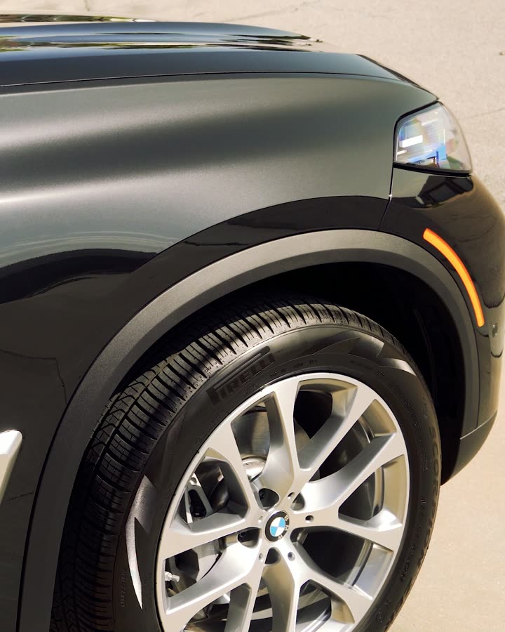 Glossy BMW receiving professional ceramic coating for long-term paint protection